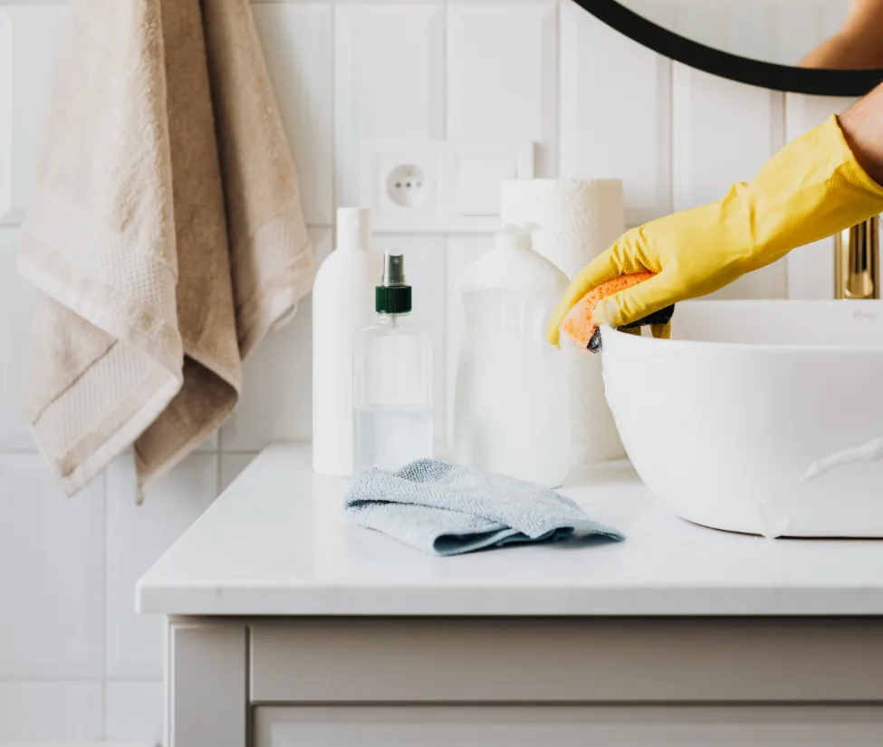 a person cleaning a bathroom